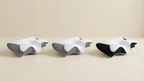 Three identical ergonomic neck support pillows shown together