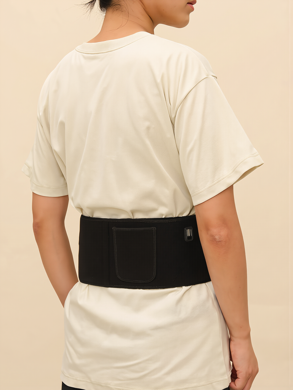 Person standing while wearing the red light therapy waist belt
