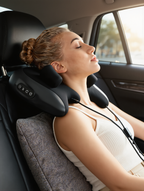 Woman in a chair using the shiatsu massage pillow on her neck