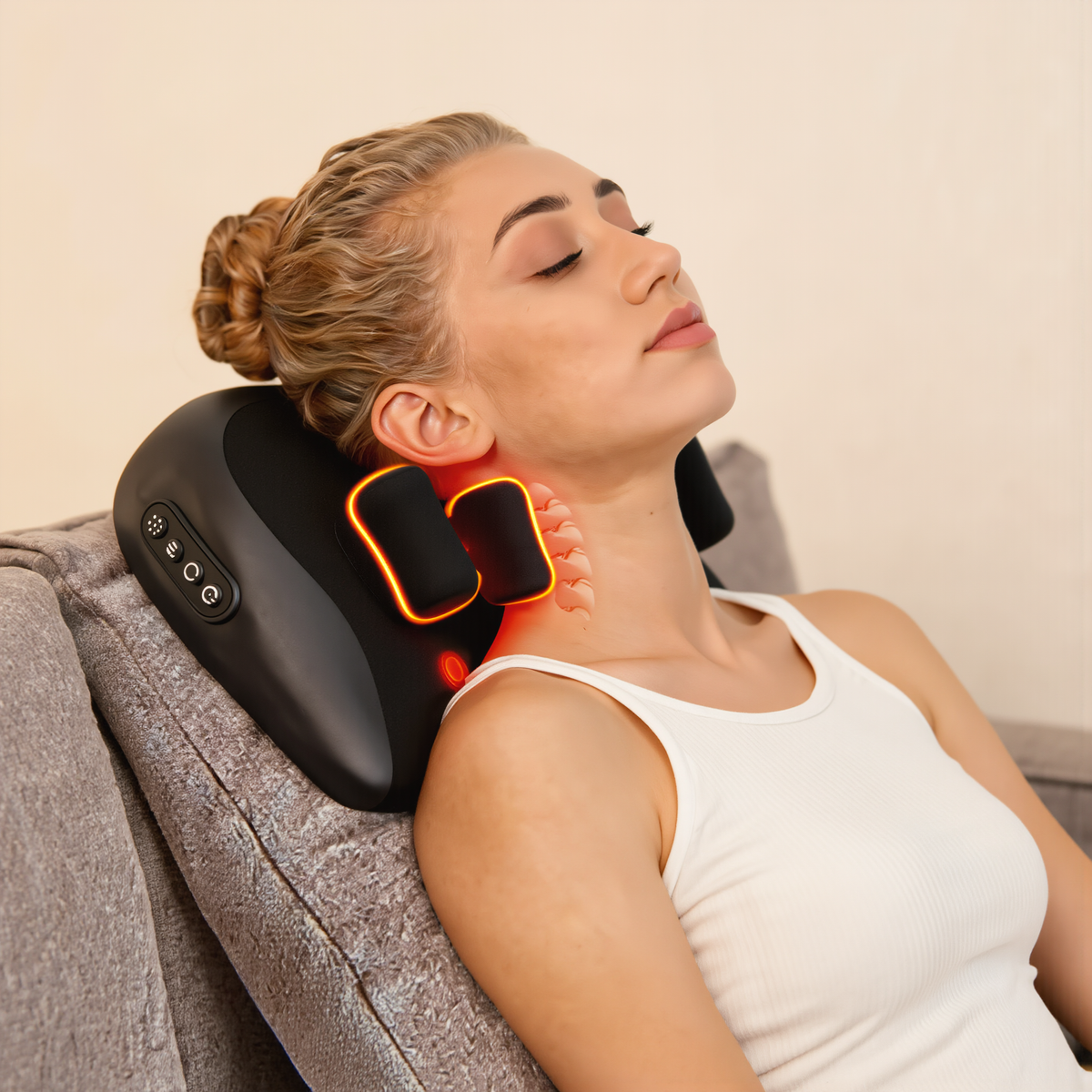 Woman sitting with the shiatsu neck and shoulder massage pillow